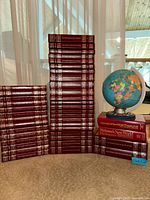 Full group of encyclopedias, year books, globe, dictionaries