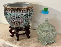 planter on wooden stand and lidded jar