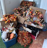 Group of wreaths, faux pumpkins and mesh ribbon in boxes and tote