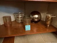 All five mercury glass pieces on shelf