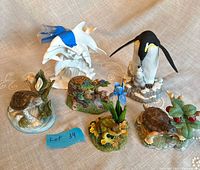 all six animal figurines arranged on cloth
