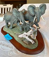 Full view of Lenox elephant sculpture on base with birds and driftwood