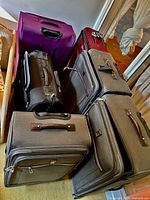 Group of six suitcases showing colors and sizes