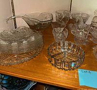 Shelf view showing platter stack, oval sauce boat, punch cups and small dishes