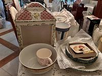 Group shot showing display box, vase, bowl with mug, plate stack with cheese set