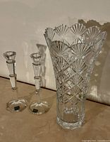 Vase and two candlesticks side by side