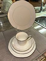 Dinner and salad plates, cup, bread plate, saucer showing platinum edge and floral pattern