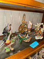Shelf view showing all bird figurines and ornament