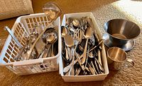 overview baskets of flatware, utensils, gravy boat, cup