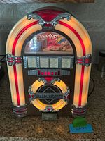 Front view lit showing dial, grille and illuminated arch