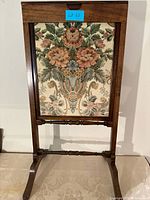 full view of wooden fireplace screen with floral panel