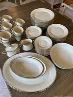 Complete set showing stacks of plates, cups, serving pieces