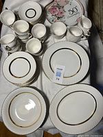 Overview of plates, cups, saucers, serving pieces on table