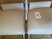 Close view of both seat cushions showing vinyl colour and tear