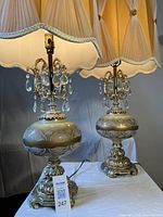 Front view of both lamps showing bases, ceramic globes, prisms and shades