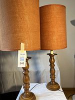 Both wooden lamps with shades displayed side by side