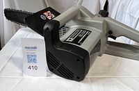 Left side view showing full chainsaw and bar with label