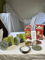 All boxes and loose canning pieces displayed on table