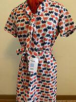 White dress with red and navy elephant print, front view on mannequin