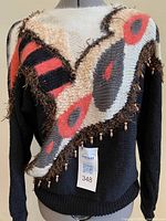 Black sweater with mohair abstract trim and beads on mannequin