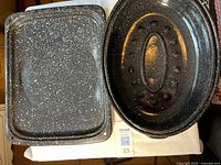 Open view showing interior surfaces of rectangular pan and oval roaster