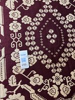 Close-up of burgundy side showing floral pattern detail and texture.