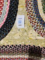 Two rugs edges with lot tag visible