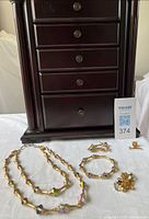 Front view jewellery box closed with jewellery pieces in front