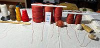 Full lot, showing standard and large thread spools plus smaller white and gold spools