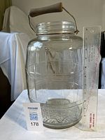 Full view of jar beside ruler showing height and handle