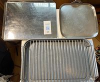 Top view of cookie sheet, square pan and roasting pan rack