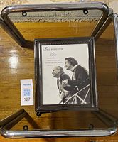 Top view of smoked glass end table with picture frame on surface