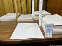 Overview showing five stacks of blank paper with size labels and ruler for scale