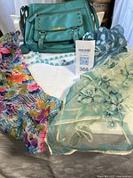 Overall shot showing purse, necklace, pendant and three scarves