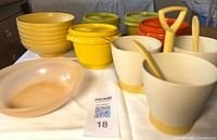 All pieces laid out: storage bowls with lids, stacked cereal bowls, serving bowl, relish set cups, spoons and handle