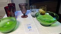 Front view of all eight colored glass items