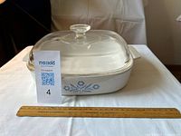 Side view of casserole with lid showing blue cornflower motif, scale ruler