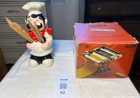 Chef utensil holder beside boxed pasta maker