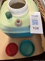 Open thermos showing mouth, caps and chipped spout