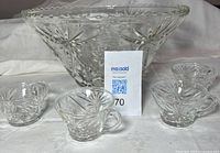 Front view of clear pressed glass punch bowl with four matching handled cups
