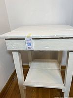 Front view of white two-tier wooden table