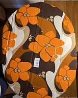 Orange floral mod print tablecloth spread on table