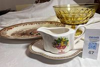 Front view of gravy boat with underplate, amber bowl, turkey platter