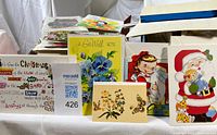 Front view showing variety of vintage greeting cards and blank envelopes in box