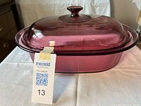 Side view of casserole with lid showing cranberry color and ribbed texture