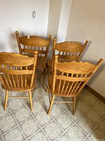 Four chairs arranged showing backs and legs