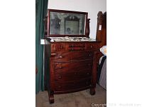 Full view of the mahogany Empire dresser with mirror showing front and side details including marble top and drawer arrangement.