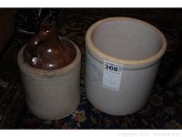 Two stoneware crocks and one brown glazed jug on a patterned rug.