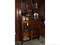 Front view of entire oak combination piece showing display cabinet on left and secretary desk on right