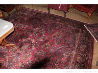 Full view of the large red paisley area rug under furniture